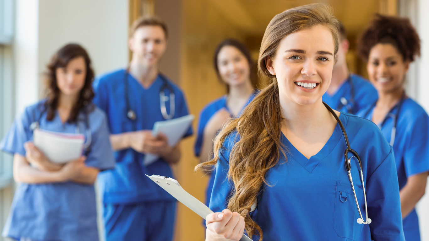 Group of healthcare professionals smiling in a medical facility, representing anesthesiologists and CRNAs living and working in the Midwest